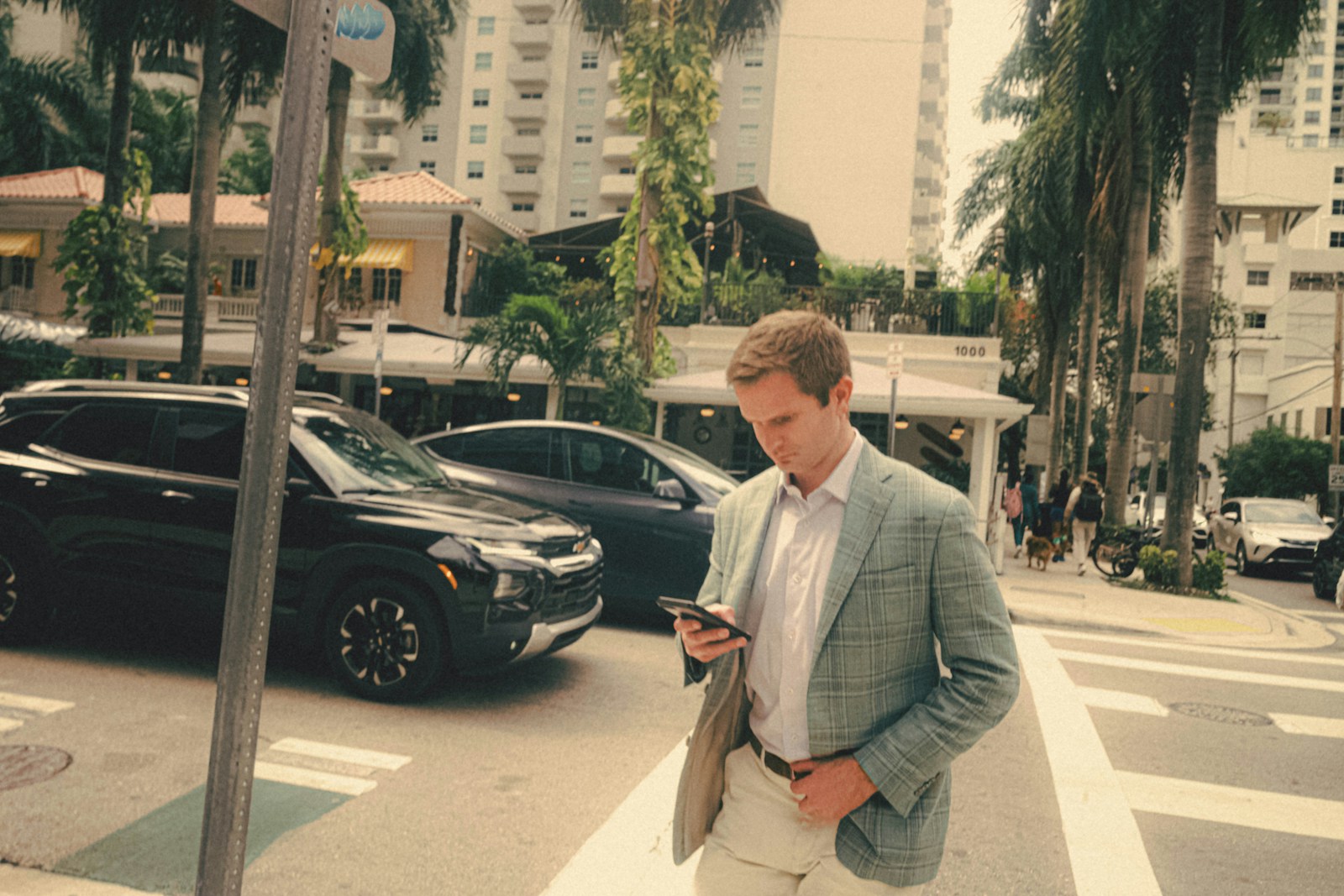 a man in a suit standing on a street corner