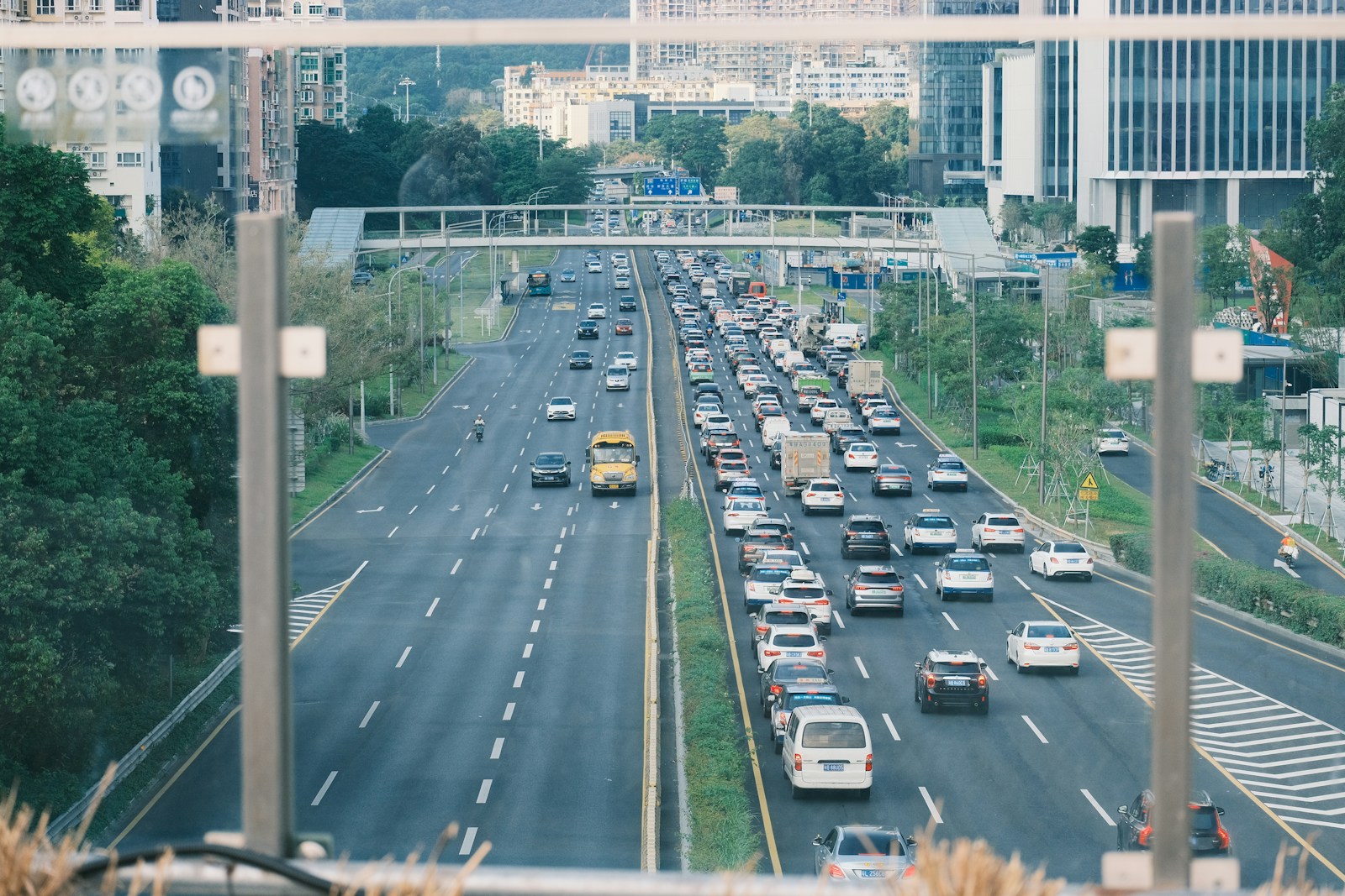 a highway filled with lots of traffic next to tall buildings
